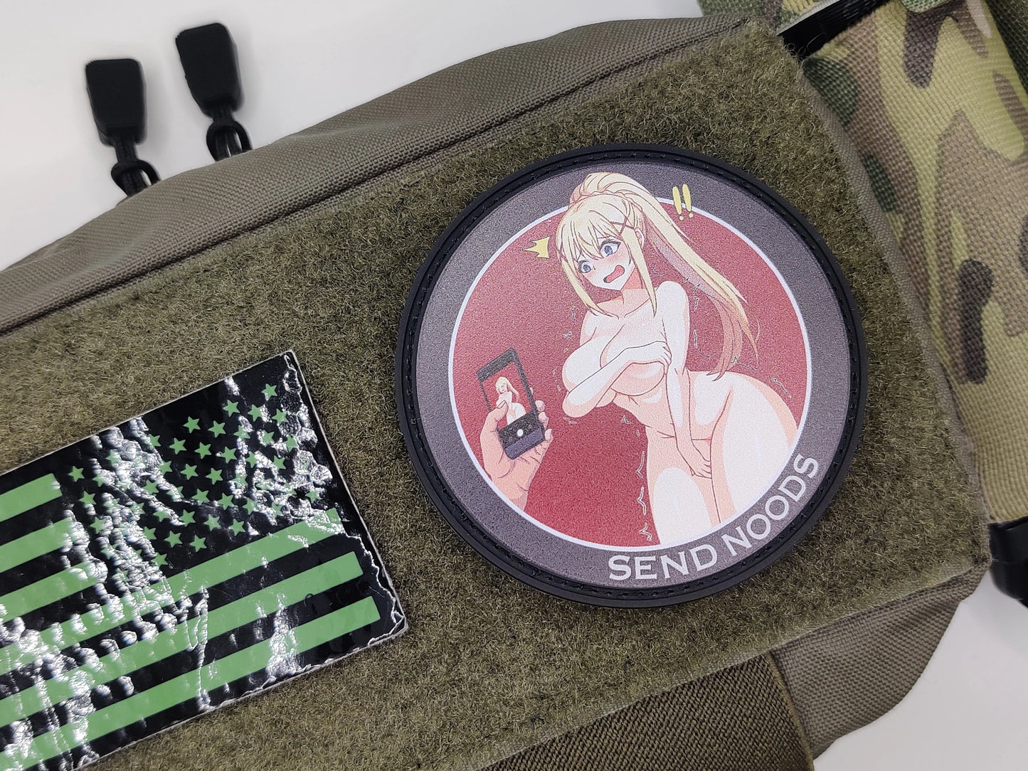 Olive green bag with anime-themed patch and American flag patch on a white background