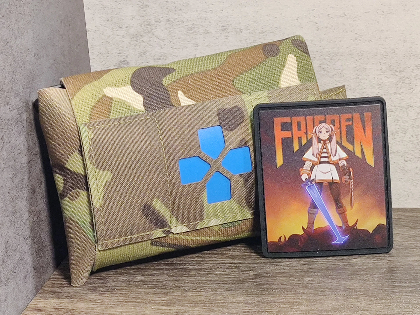 Custom made UV-Printed PVC patches featuring Frieren, from Frieren: Beyond Journey's End in fusion with the popular video game, Doom. Frieren now stands as the new demon slayer that rips and tears any mortally-challenged being that stands in her way!
