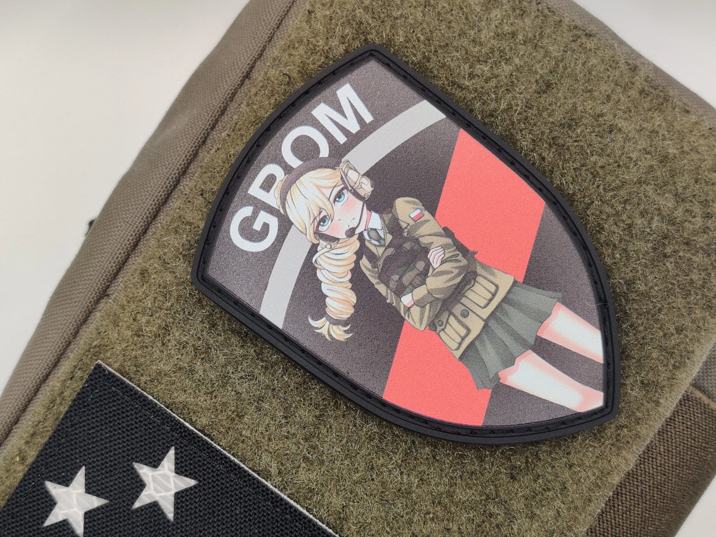 Patch with Jajka and 'GROM' text on a green texture background