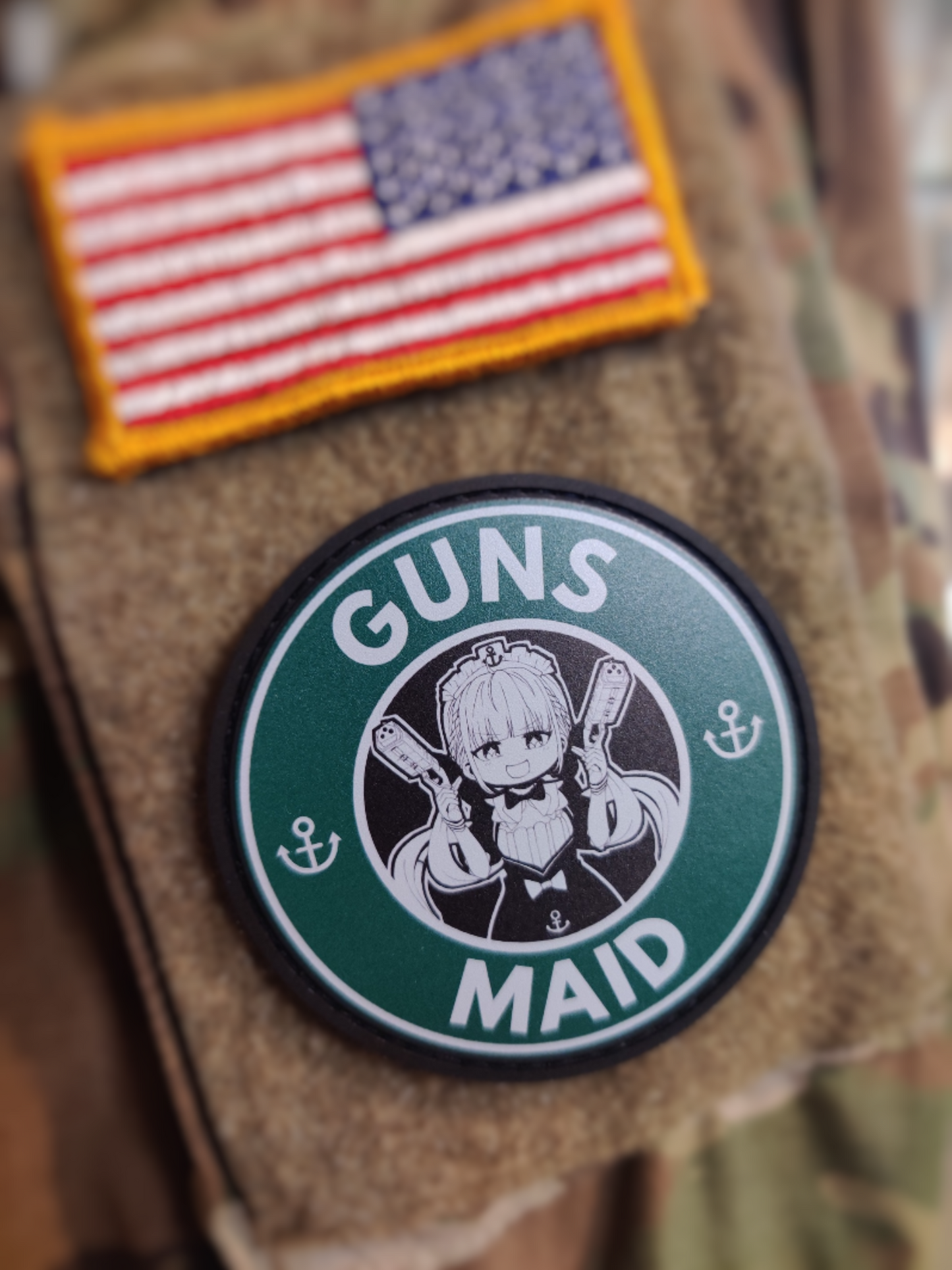 Patch with 'Guns Maid' design on a camouflage background