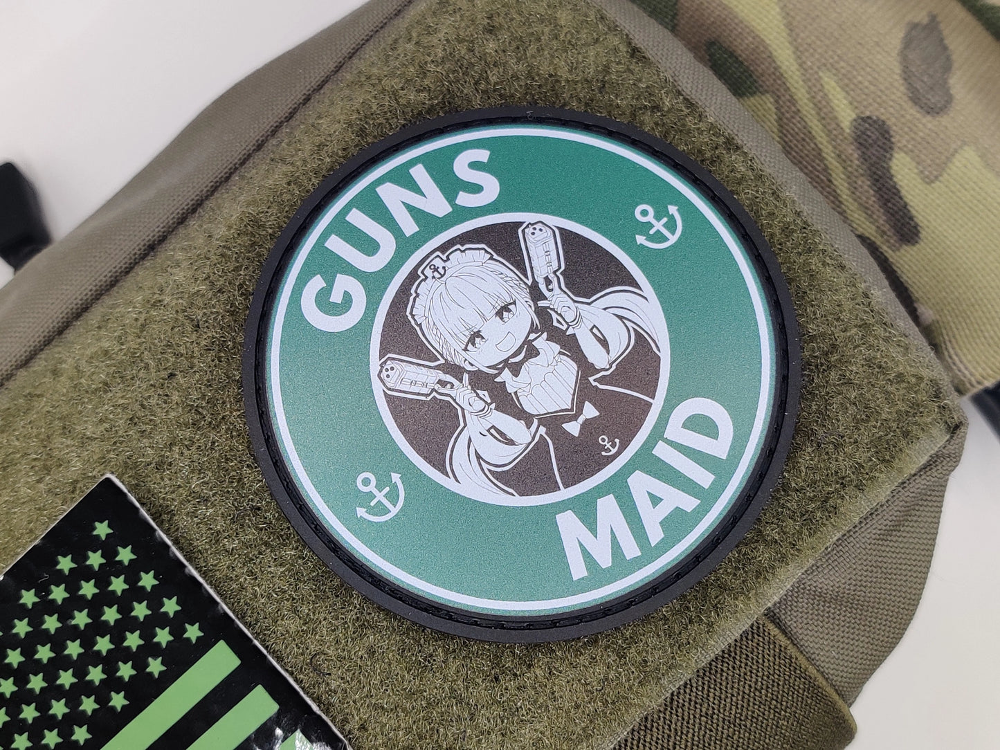 Patch with 'GUNS MAID' design on a green background