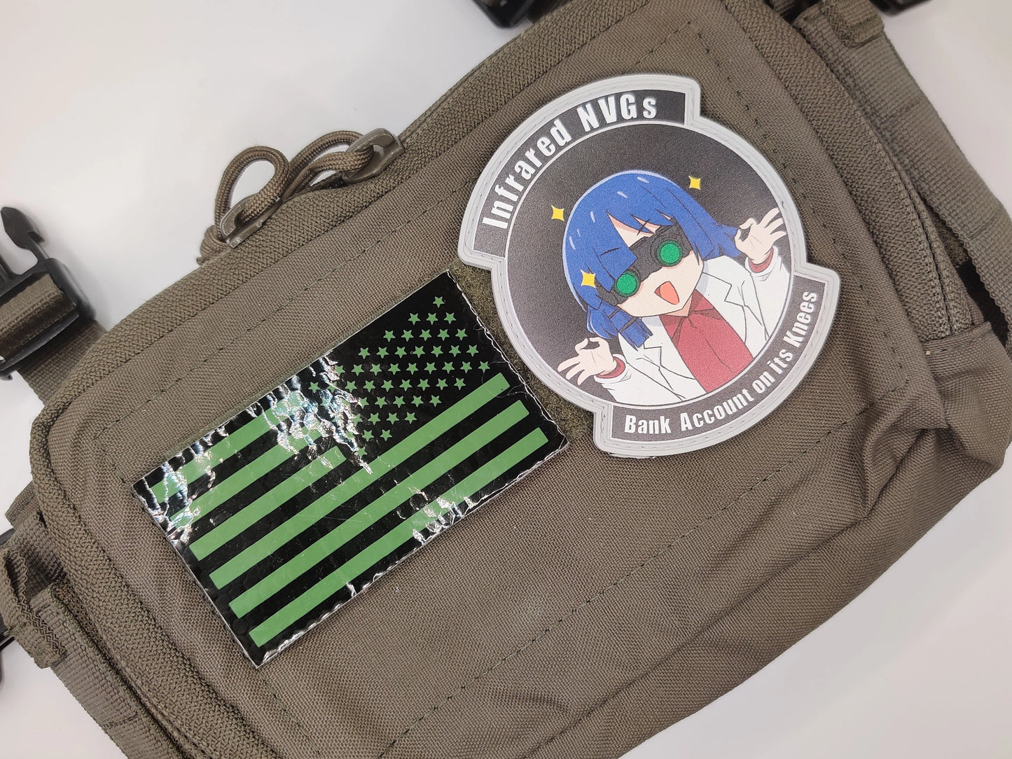 Brown pouch with patches including an anime character and a green and black flag design.
