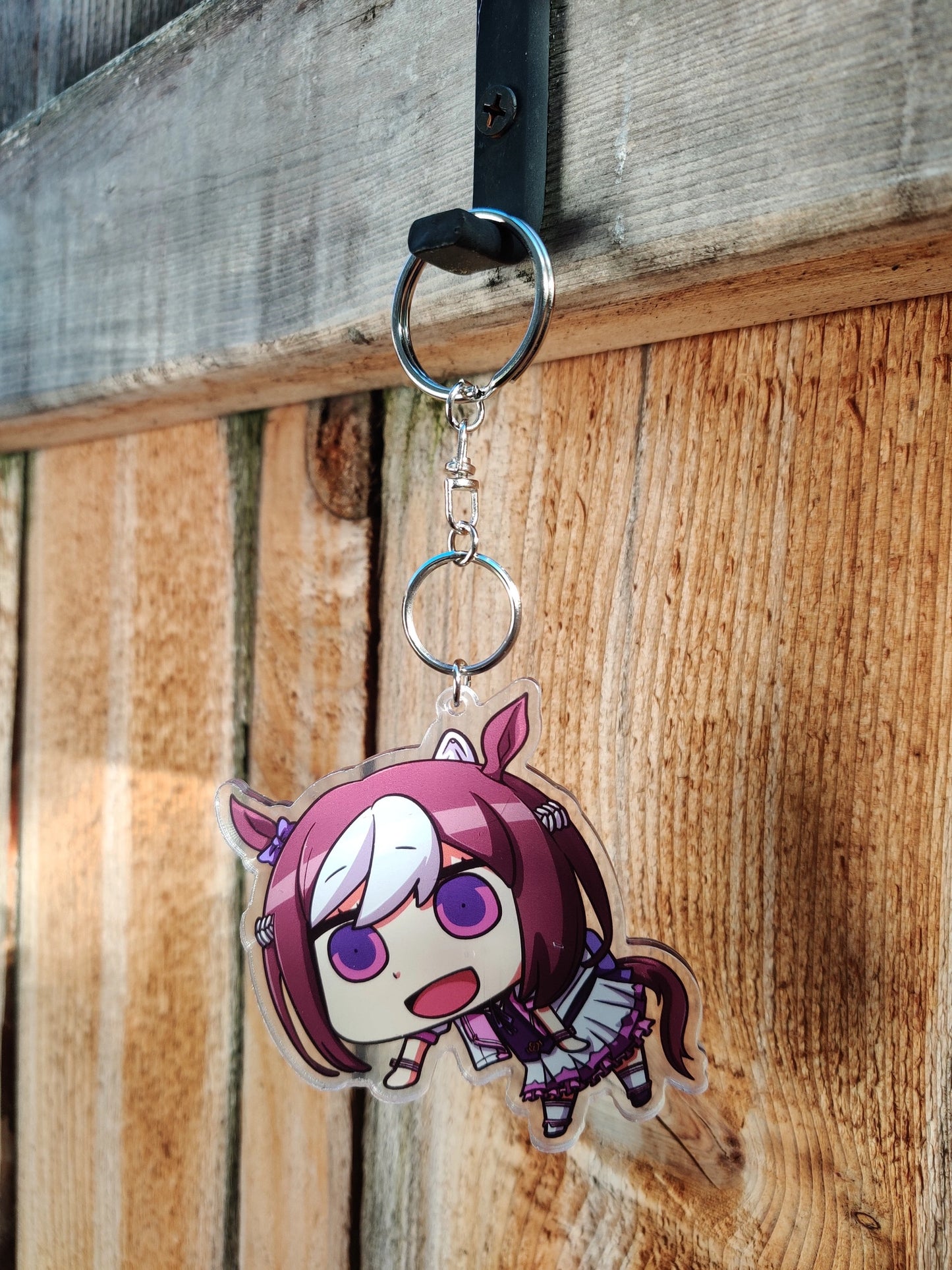 Anime character of Special Week from Uma Musume on wooden background