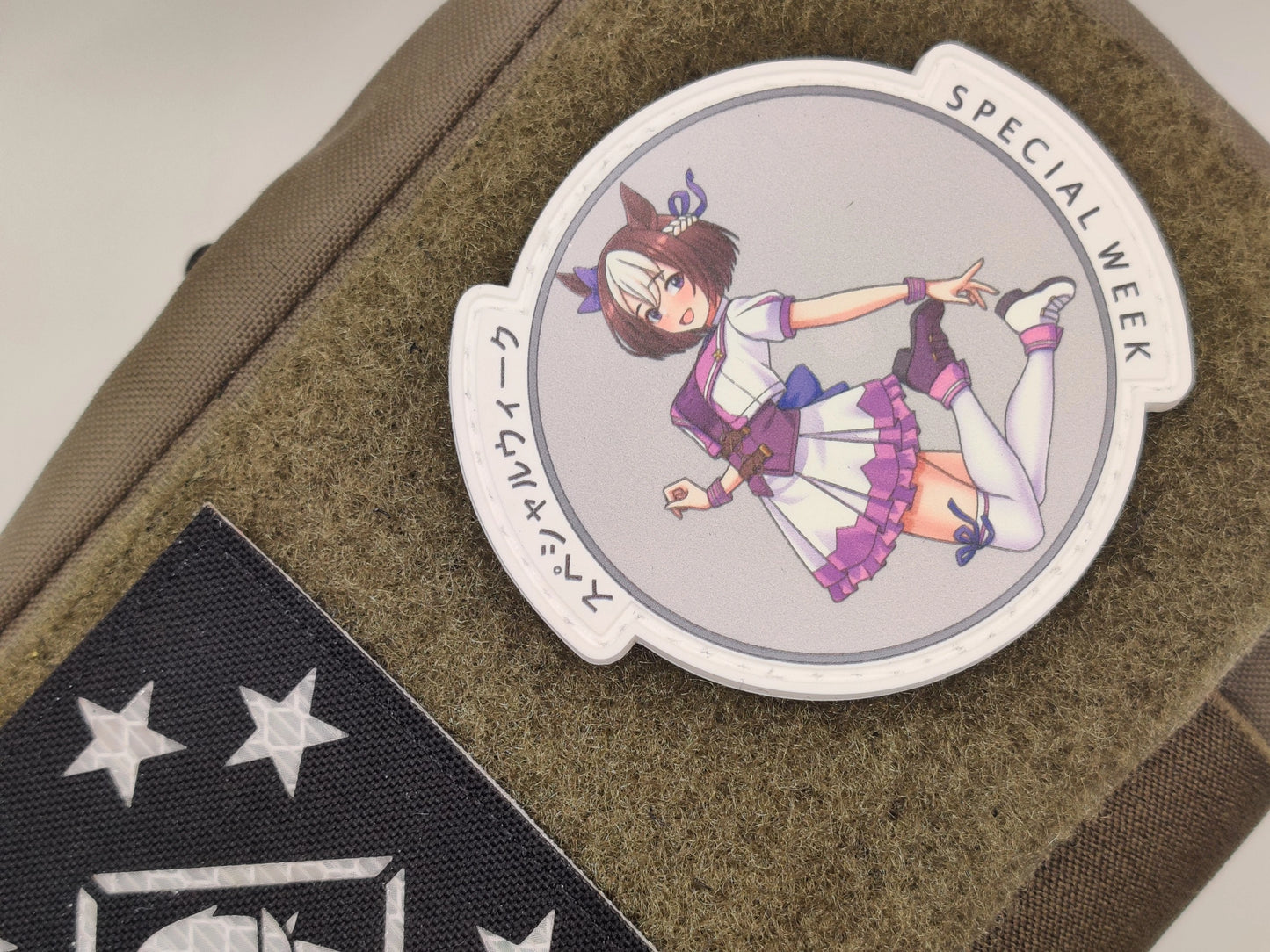 Circular patch with special week from uma musume pretty derby on a brown surface