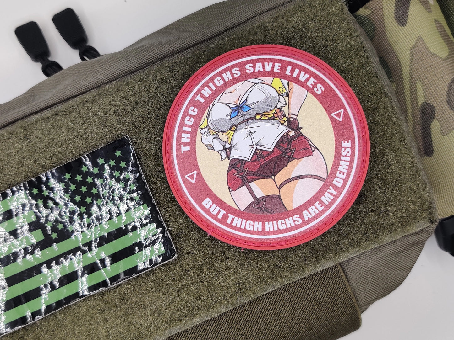 Patch on a bag with text 'Thigh highs Save Lives' and an illustration of a person in a helmet.