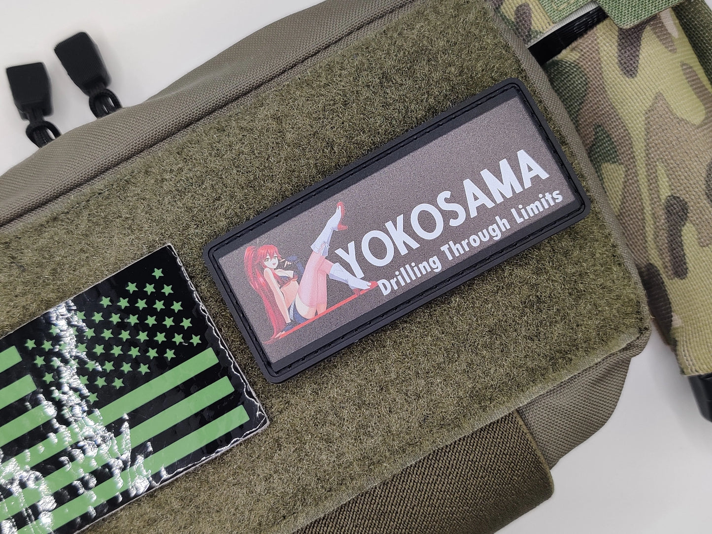 Green tactical pouch with patches including a flag and 'YOKOSAMA' branding.