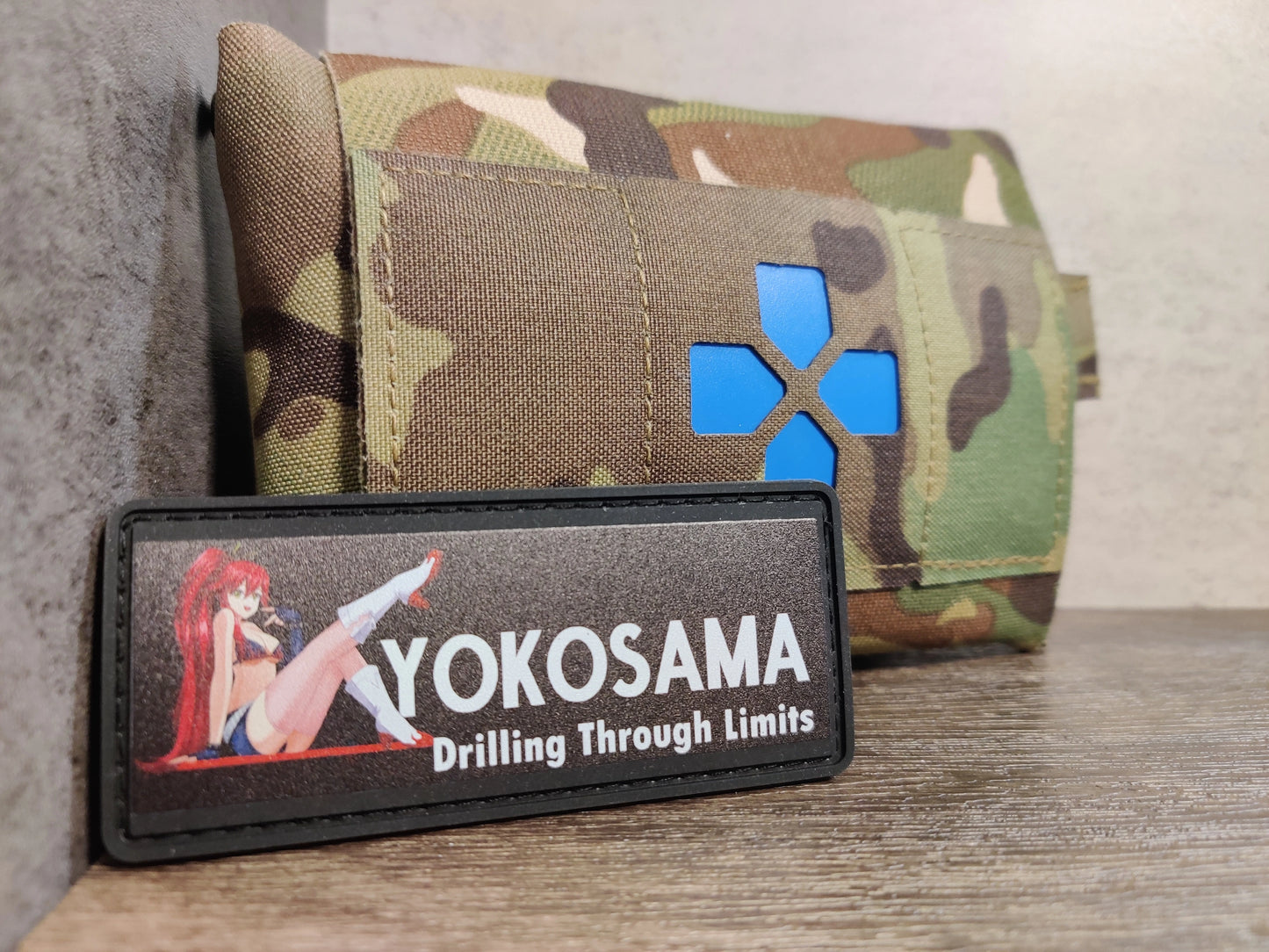 PVC patch with 'YOKOSAMA' branding and graphic design on a camouflage background