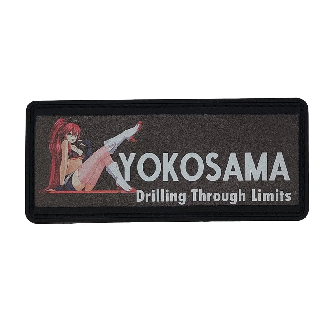 Rectangular patch with an anime-style character and text 'YOKOSAMA Drilling Through Limits' on a black border.