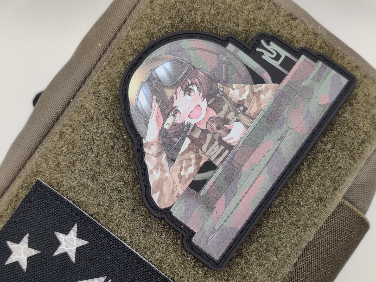 Yukari from Girls und Panzer wearing a helmet sitting on a hatch of a tank with camouflaged pattern , saluting, on a green texture background