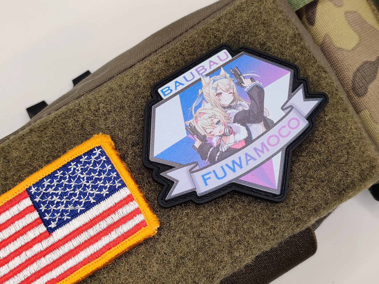 Demon Dogs Legion - Hololive Advent patch on a textured surface, one with an American flag design and the other with fuwamoco and the text bau bau and the text fuwamoco