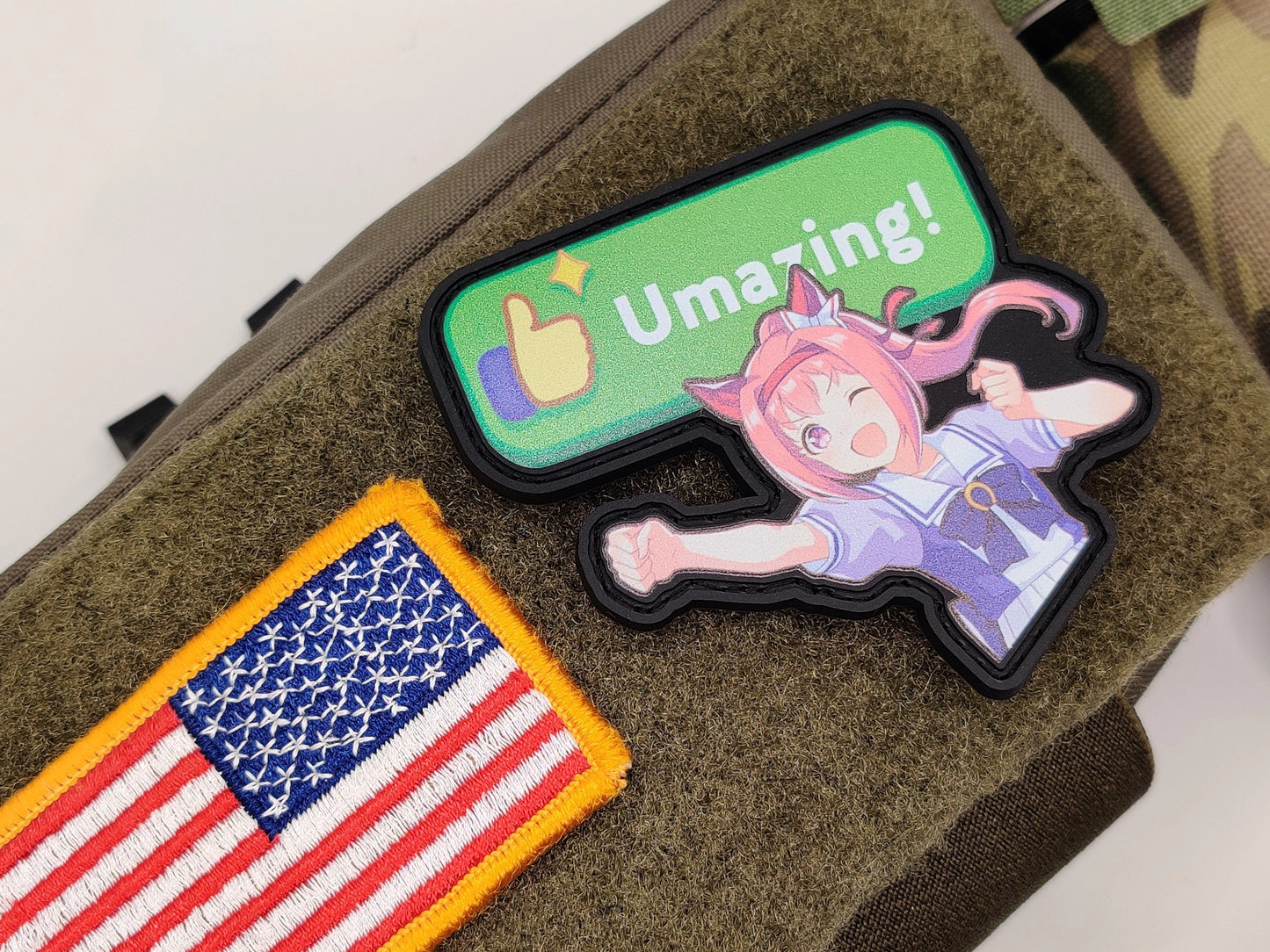 Haru Urara Umazing Patch on a green surface, one with an American flag and the other with Haru Urara and 'Umazing!' text.