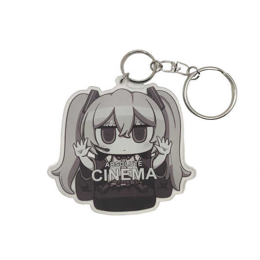 Keychain with anime character Hatsune Miku wearing a 'Absolute Cinema' shirt on a white background