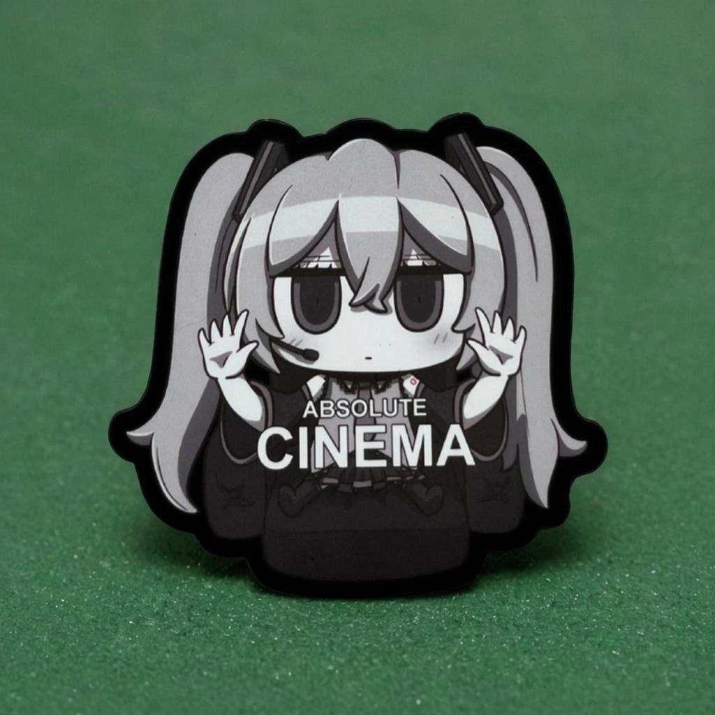 Pin with anime-style character Hatsune Miku wearing a hoodie with 'Absolute Cinema' text on a green background