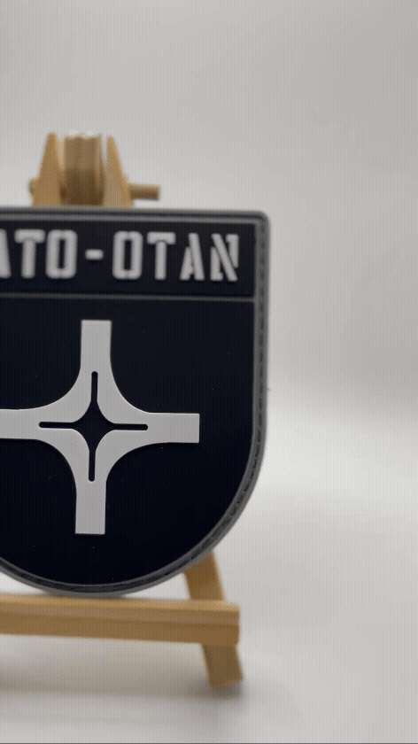 NATO-OTAN logo on a black background
