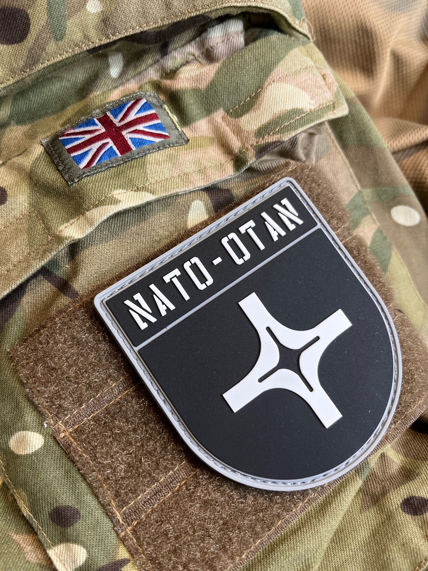 NATO-OTAN patch on a camouflage background