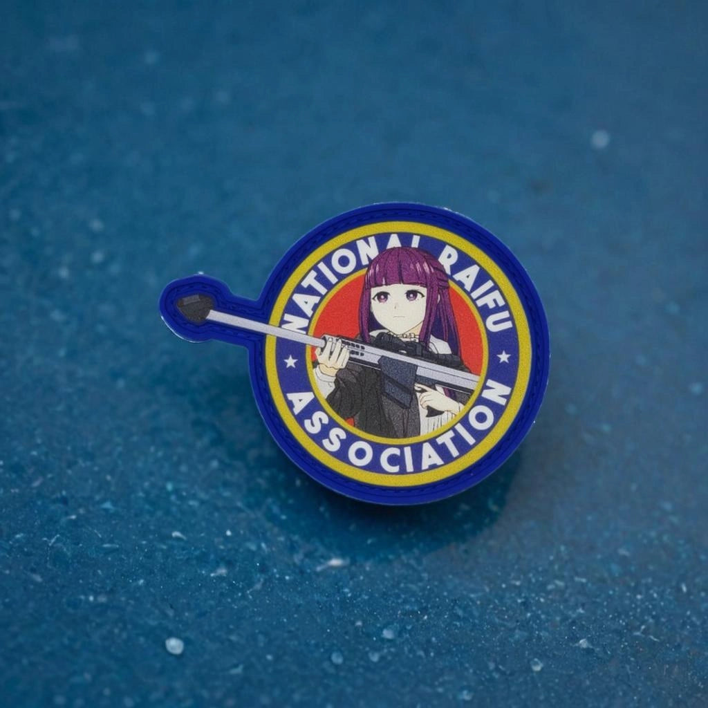 Pin with an illustration of a character holding a weapon and 'National Raifu No.' text on a blue background