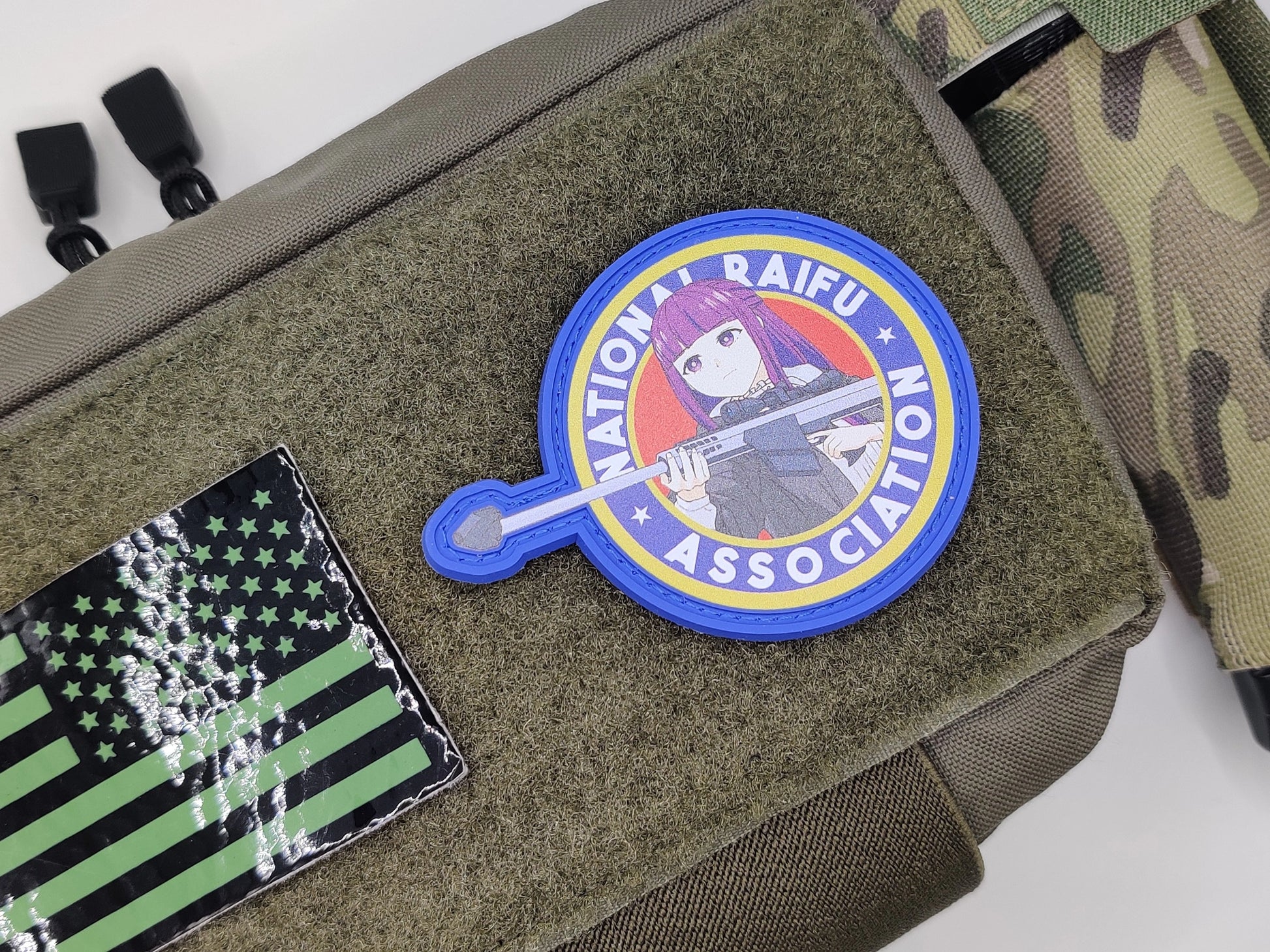 Patch with a character holding a gun and 'Nation Traifu Association' text on a green bag.