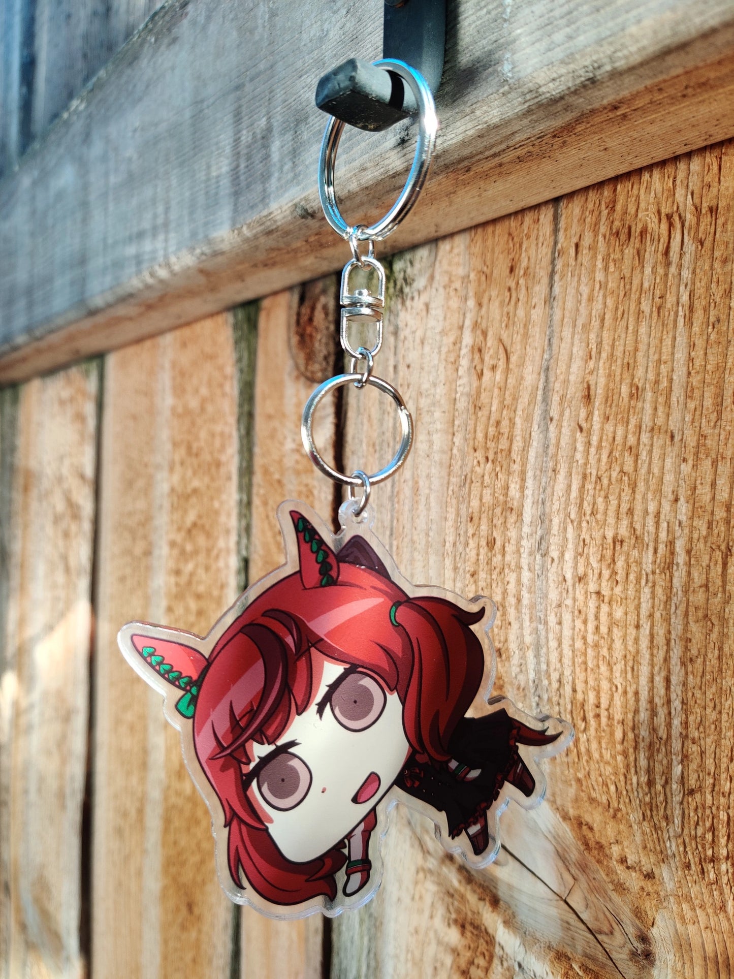 Anime character of Nice Nature from Uma Musume hanging on a wooden surface