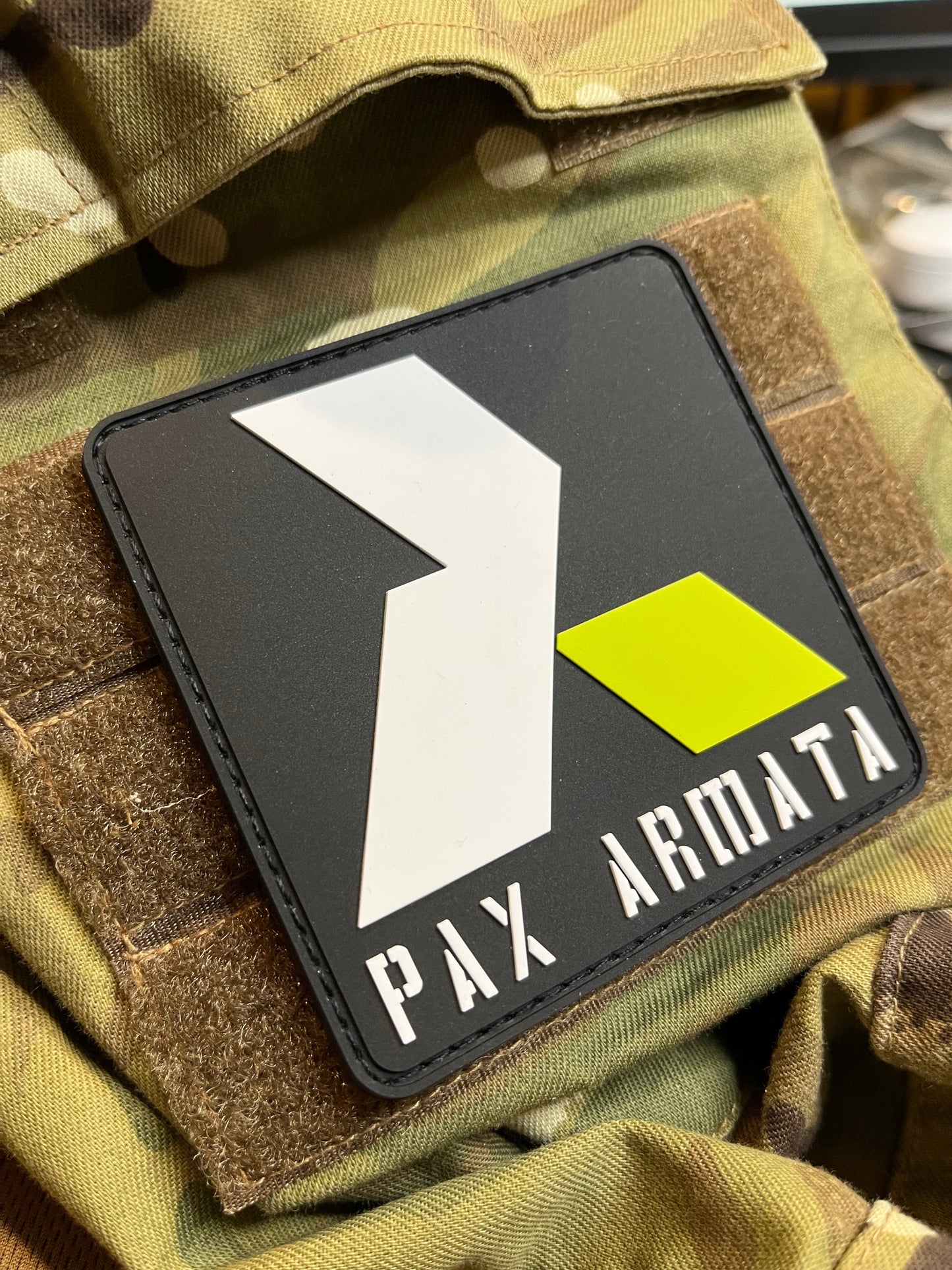 Pax Armata patch on a camouflage jacket