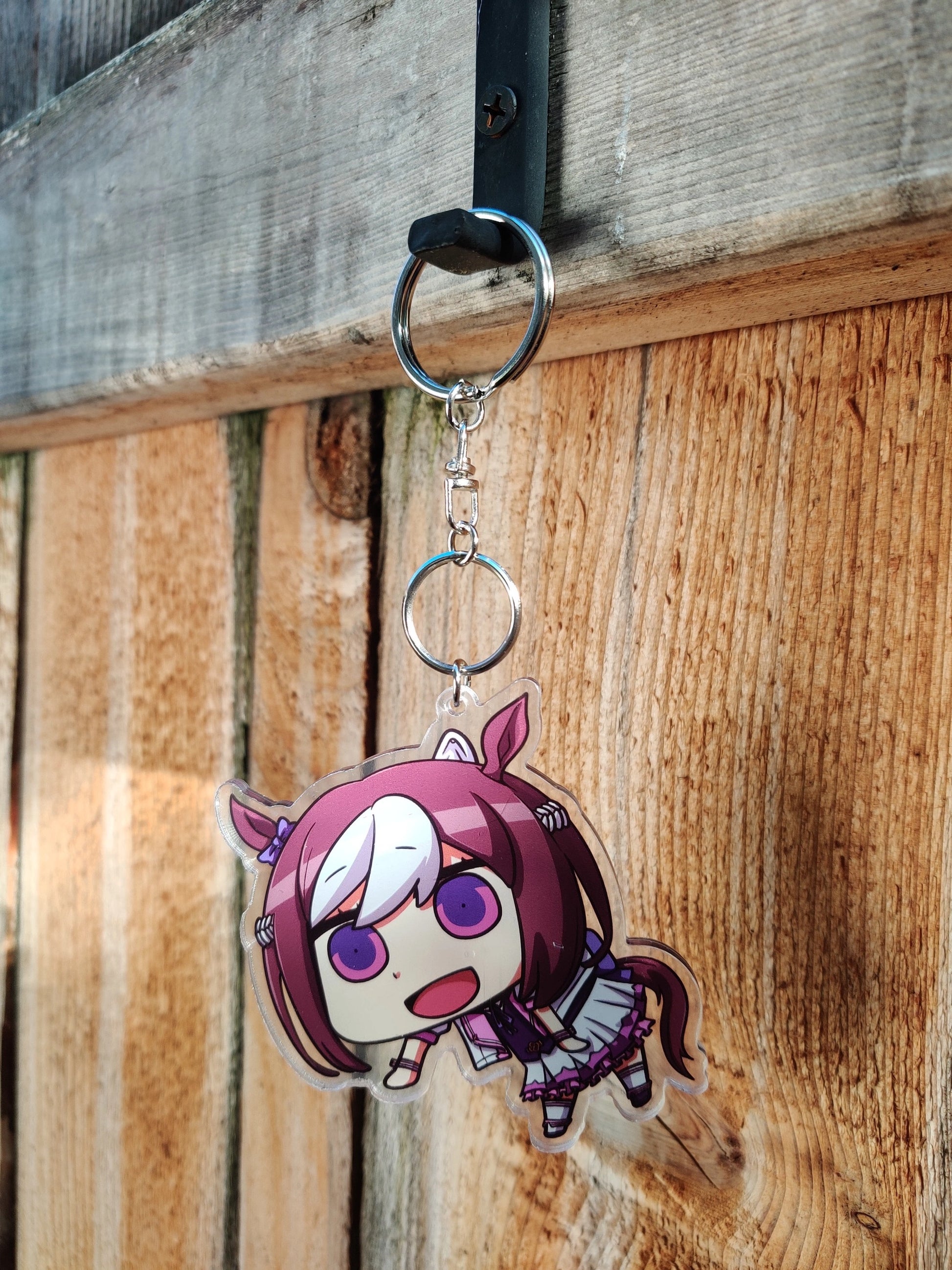 Anime character of Special Week from Uma Musume on wooden background