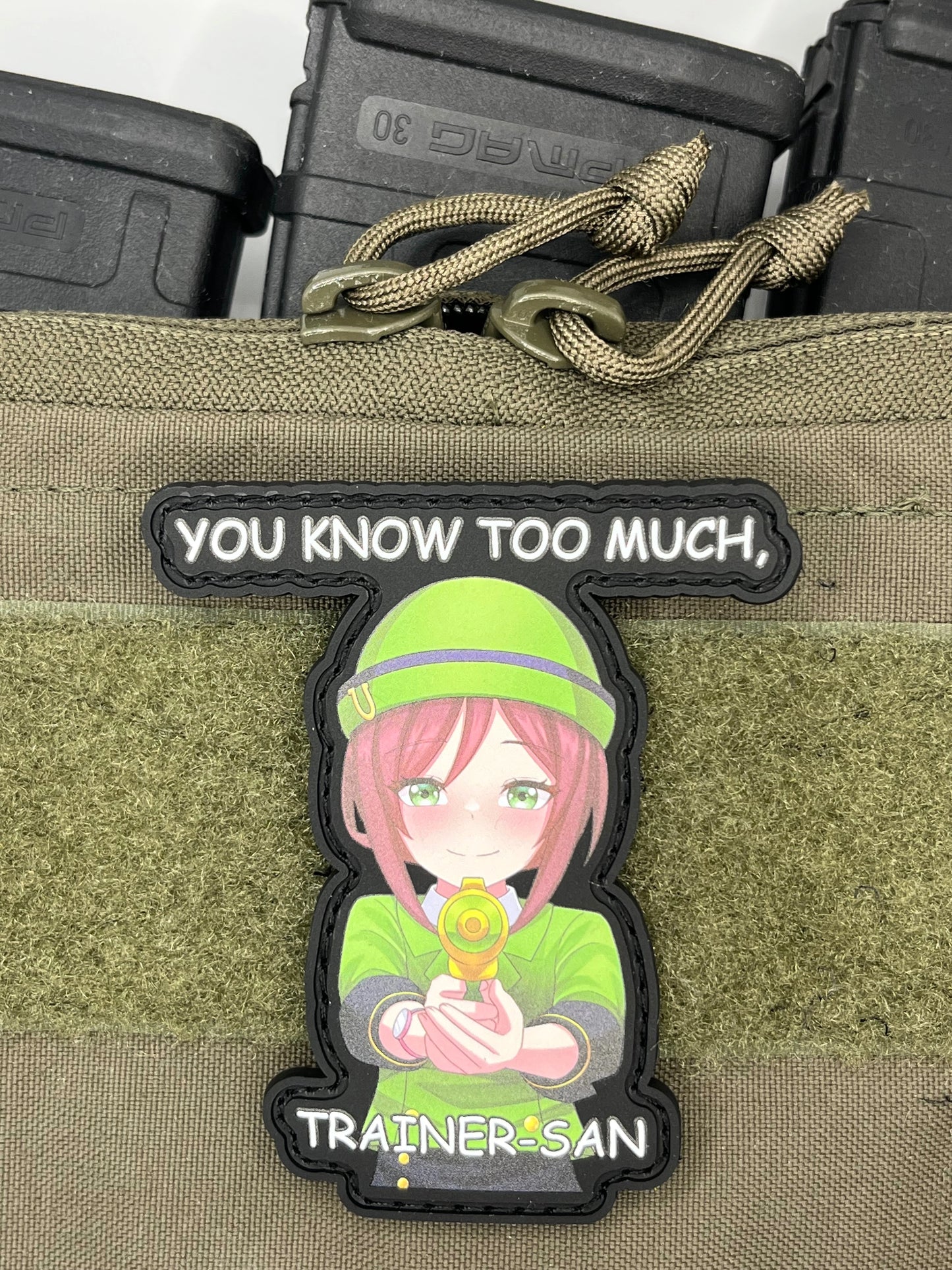 Patch of tazuna from uma musume with text you know too much, trainer san on a tactical pouch