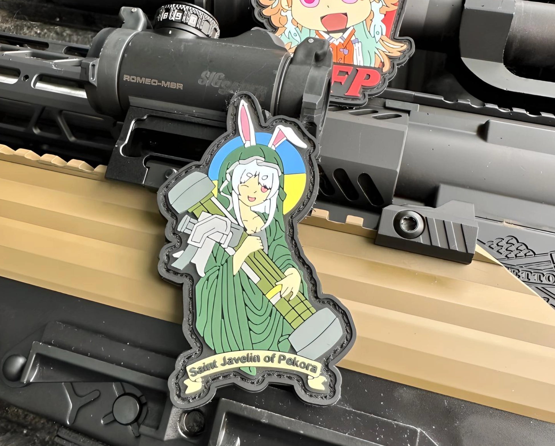 Anime character patch on a rifle with visible brand names