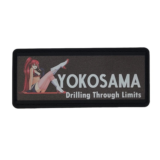 Rectangular patch with an anime-style character and text 'YOKOSAMA Drilling Through Limits' on a black border.