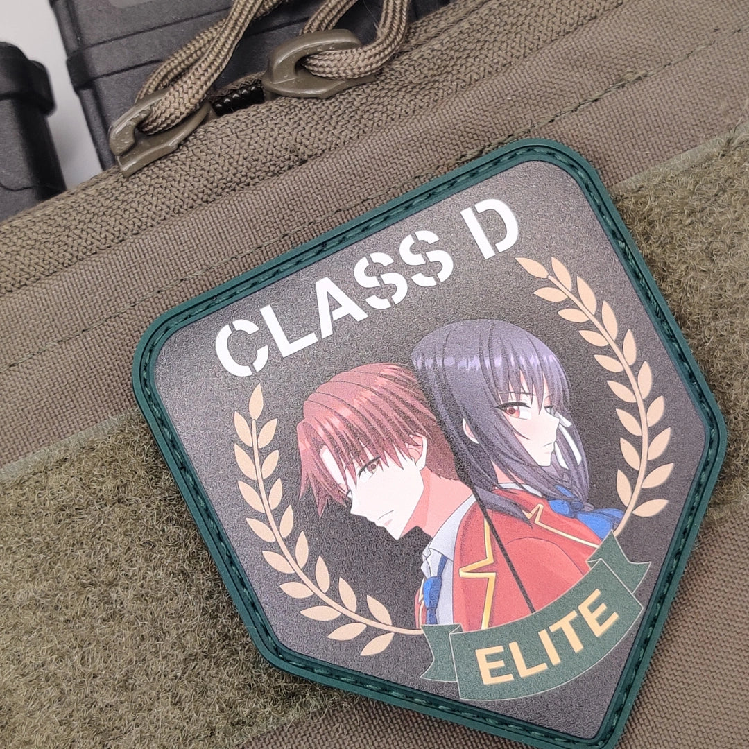 Green border Class D Elite anime patch attached to a tactical bag with paracord zipper pulls above