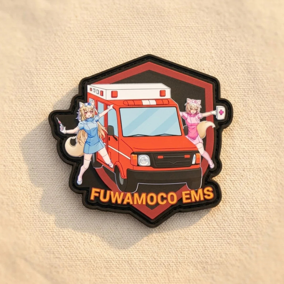 FUWAMOCO EMS patch featuring Fuwawa and Mococo in paramedic uniforms with ambulance design and hook-and-loop velcro backing on light tan fabric