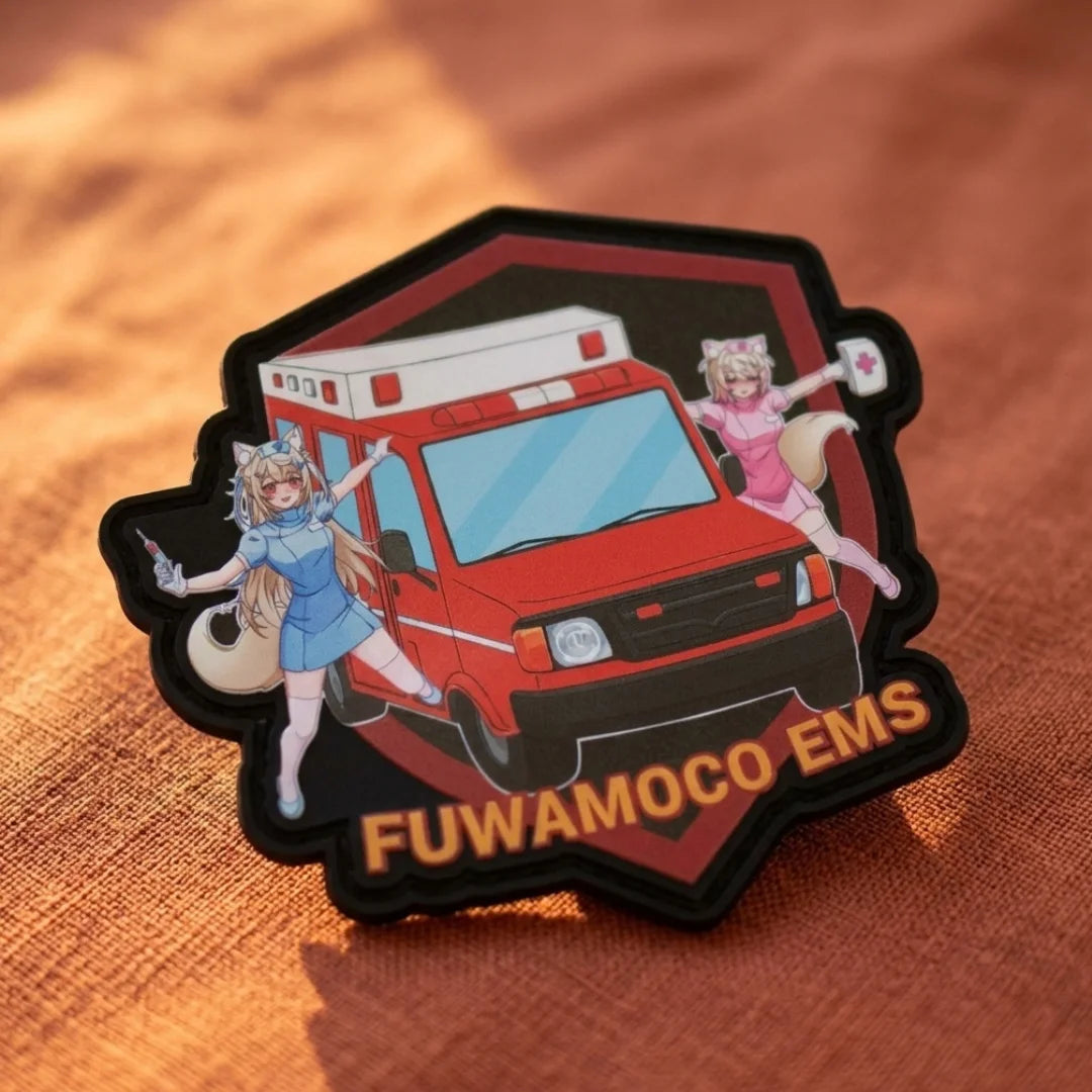 FUWAMOCO EMS patch 3.4 inches featuring Fuwawa and Mococo paramedics with red ambulance vehicle and "FUWAMOCO EMS" text displayed on warm fabric