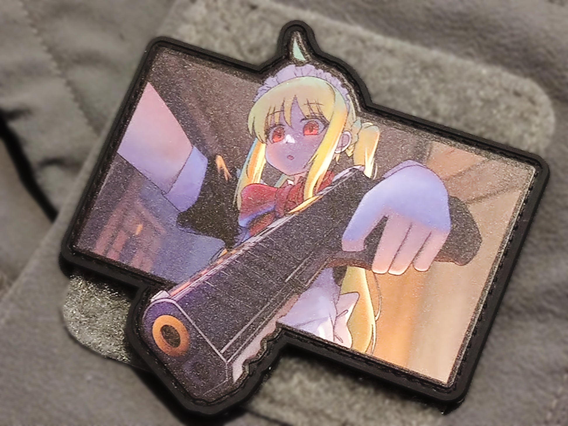 Anime character with a gun on a clothing textured surface