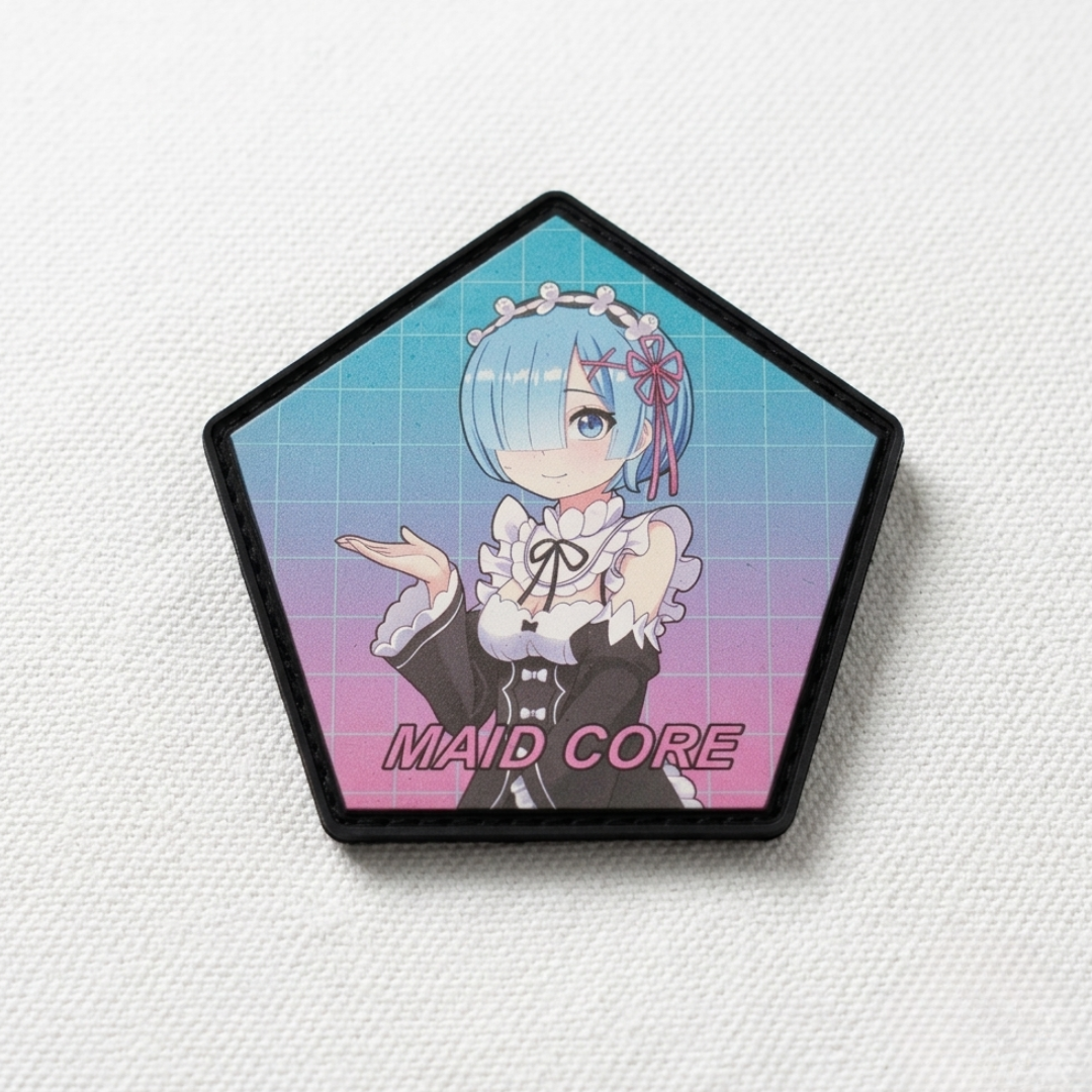 A pentagonal pin badge featuring the anime character Rem from Re:Zero as Maid Core, with a blue and pink gradient background and a black border, displayed on a textured white surface.