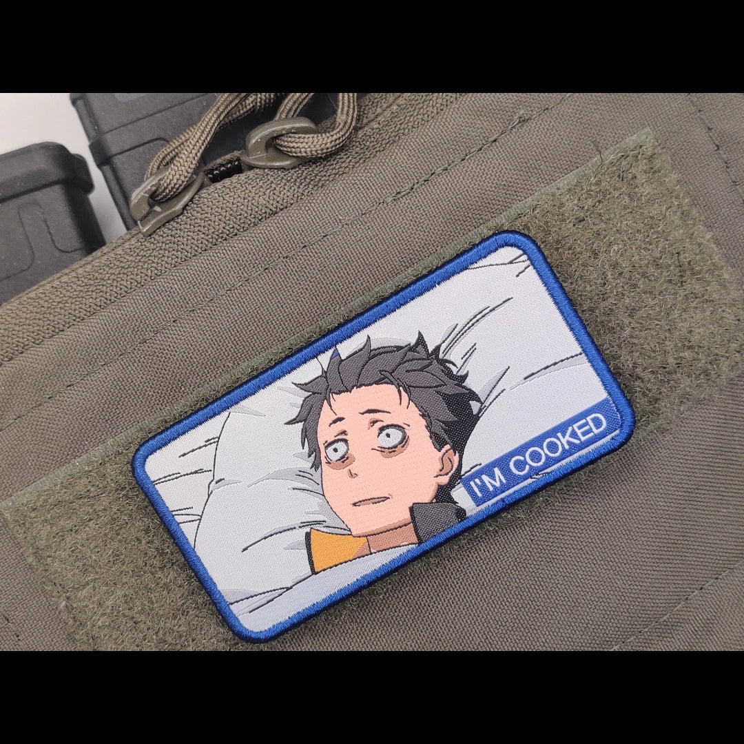 Close-up of Natsuki Subaru "I'm Cooked" meme patch on tactical bag — detailed Re:Zero anime Velcro hook patch showing embroidery and "I'm Cooked" text